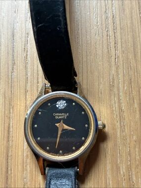 Vintage Quartz Women's Black and Gold Dress Watch by Bulova